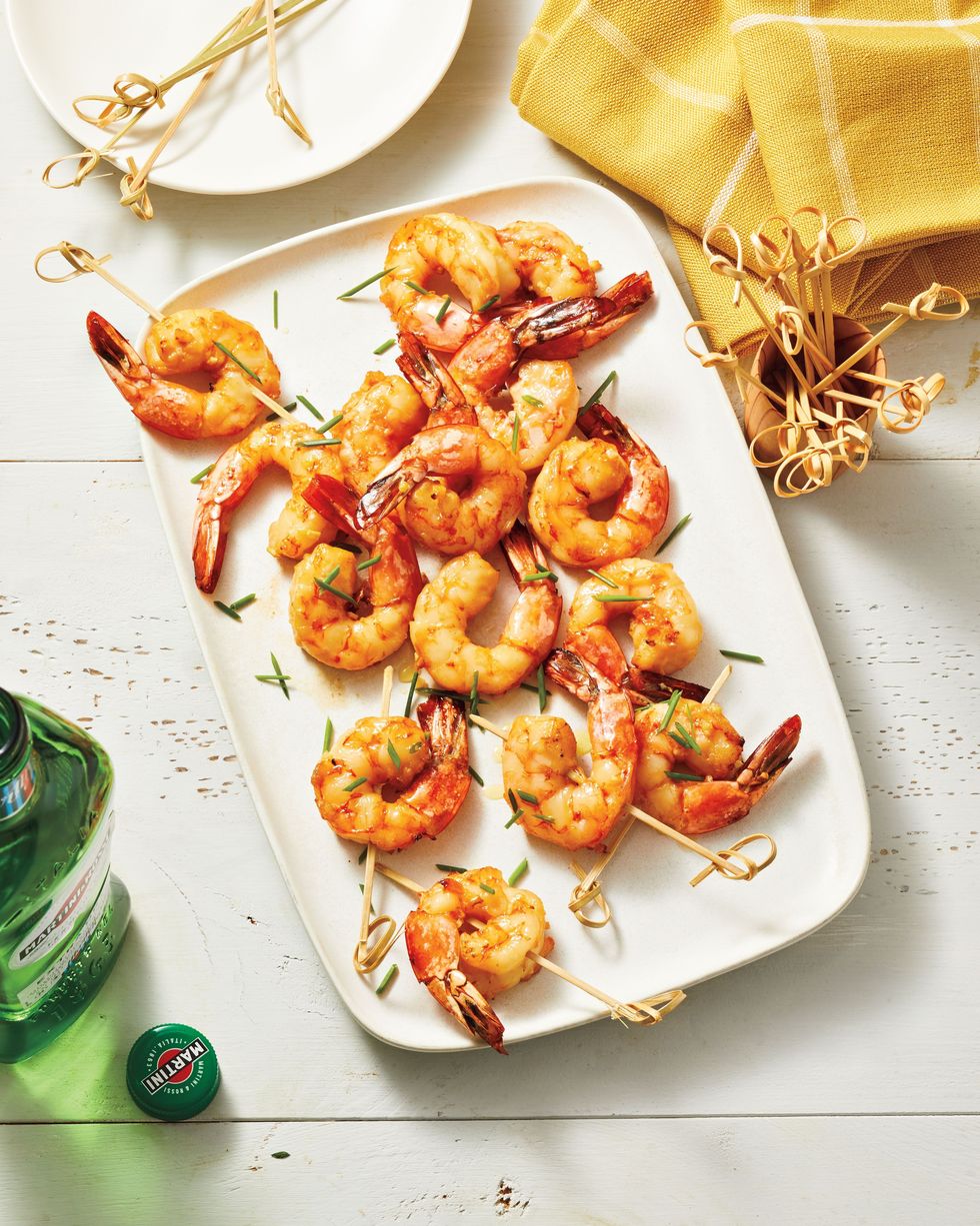 vermouth air fried shrimp on toothpick arranged on a white rectangle serving plate